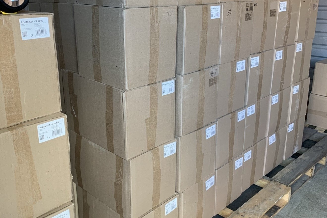 A storage unit filled with sealed inventory cartons stacked on pallets.