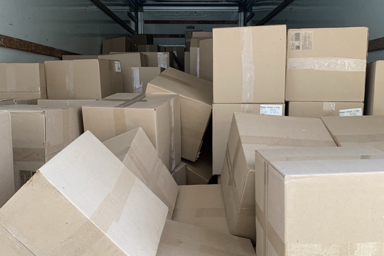 Cargo truck filled with cartons in an uneven emergency load.